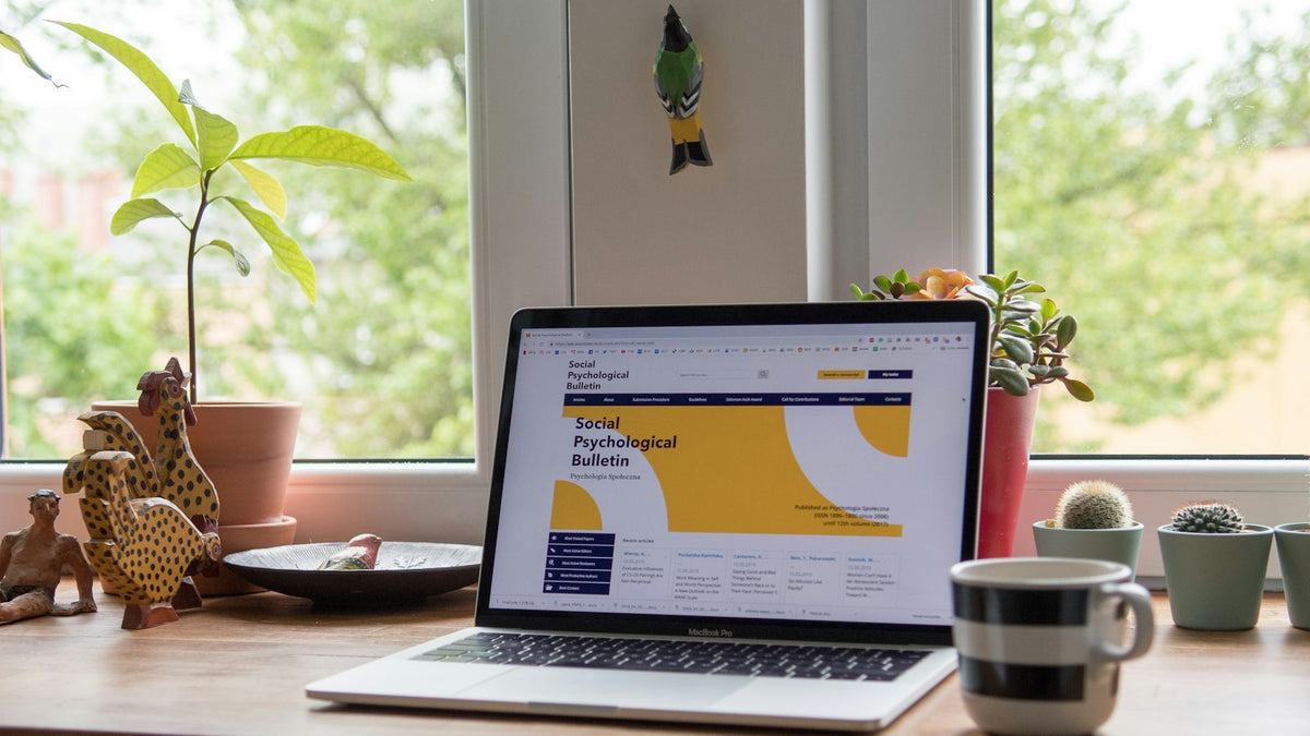 Laptop displaying a custom website design on a desk